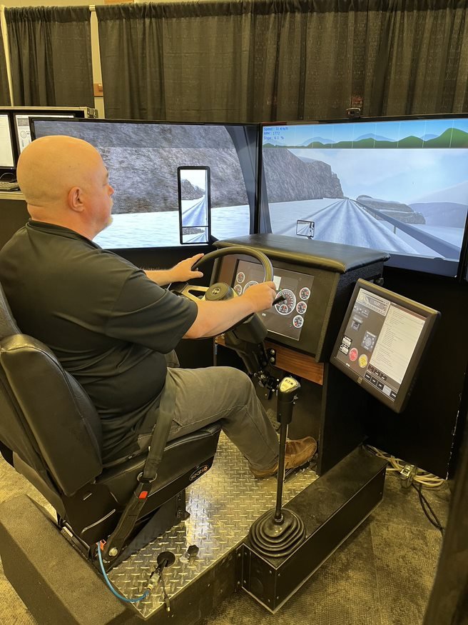 driver is learning to drive on the truck driving simulator