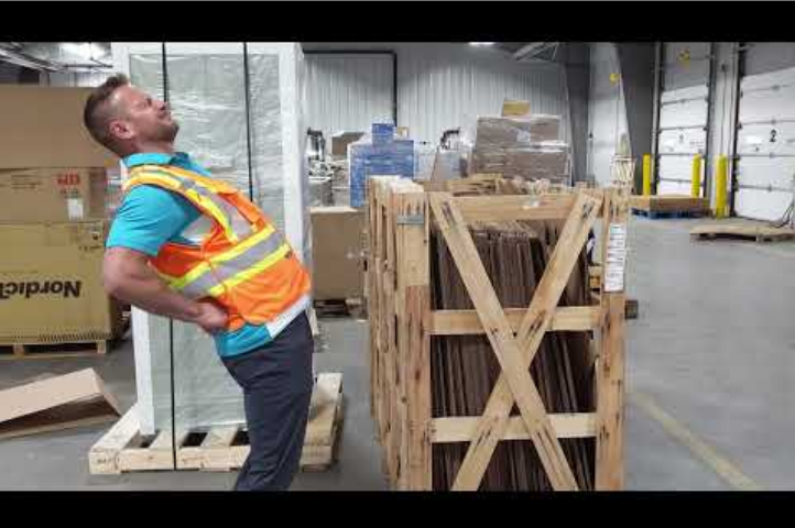 Warehouse employee stretching their back