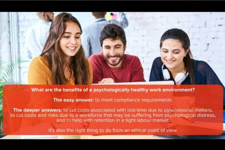 three people smiling and looking at a laptop screen