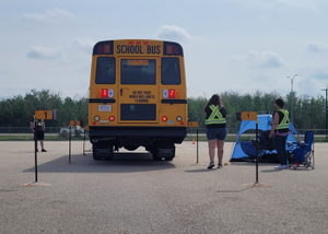Alberta Provincial School Bus in a lot during daytime