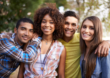 Young Canadians smiling while hanging out at a park