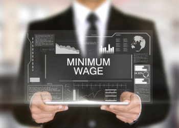 Business Man Holding Screen with Minimum Wage Graphic