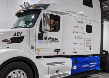 Mike Harnett sitting inside a Cooperative Truck Platooning System truck
