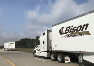 Two CTPS Bison Trucks Driving Down Highway