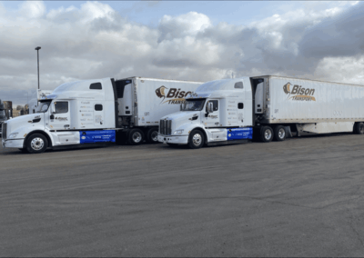 Two CTPS Bison Trucks parked in a parking lot
